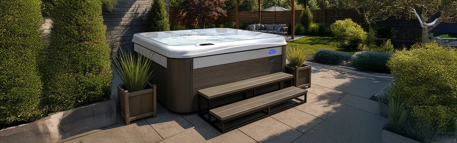 Cal Spas Patio hot tub with steps and planters in a landscaped garden